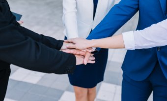 Group of professionals joining hands together